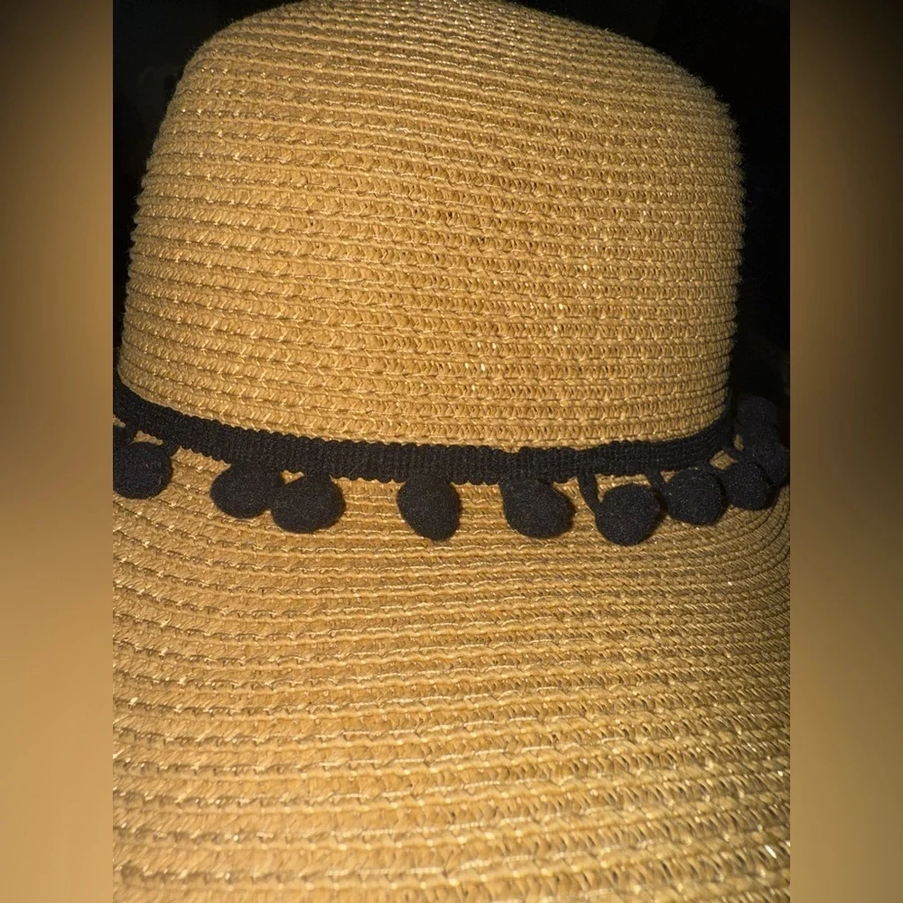 Hundred hearts straw oversized sun hat with black poms around the crown